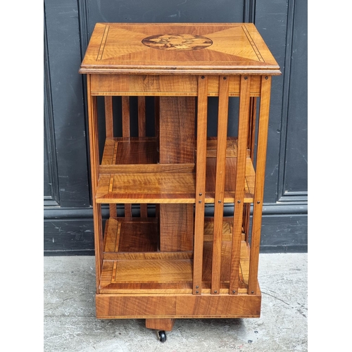 1032 - A small walnut, inlaid and tulip wood crossbanded revolving bookcase, 45cm wide.... 