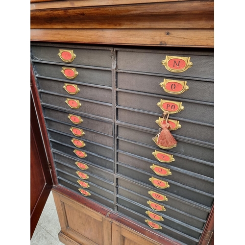 1035 - An unusual mahogany cabinet, the upper section fitted with twenty four small filing drawers, 142.5cm... 