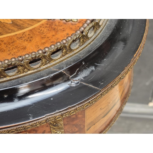 1043 - A Louis XV style burr walnut, ebonised and inlaid jardiniere, 46cm wide.