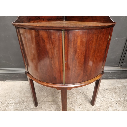 1051 - An antique mahogany bowfront corner washstand, 66.5cm wide.