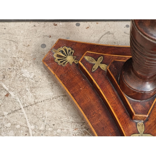 1052 - A George IV mahogany and brass pole screen, with later panel.