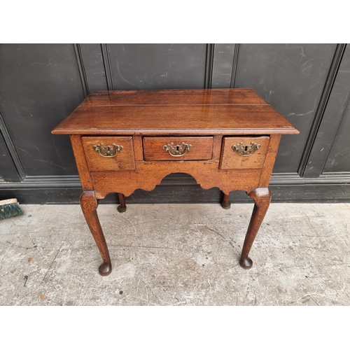 1054 - An 18th century oak lowboy, 76.5cm wide.