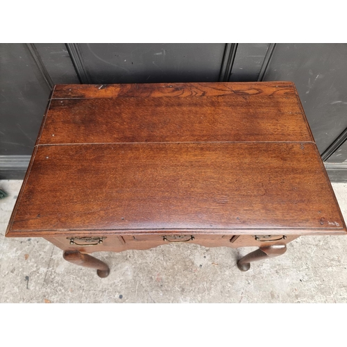 1054 - An 18th century oak lowboy, 76.5cm wide.