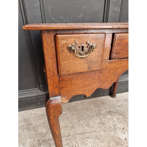 1054 - An 18th century oak lowboy, 76.5cm wide.