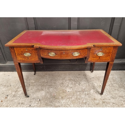 1055 - A circa 1900 mahogany and inlaid bowfront writing table, 107cm wide.