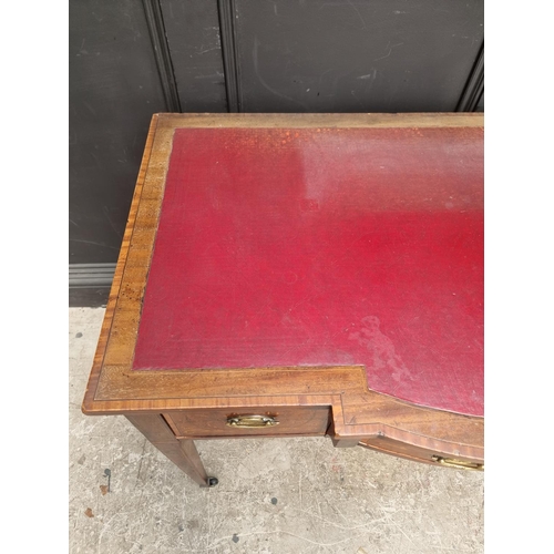 1055 - A circa 1900 mahogany and inlaid bowfront writing table, 107cm wide.