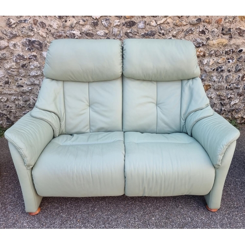 1067 - A Himolla 'Chester' pale green leather two seater settee, 150cm wide.