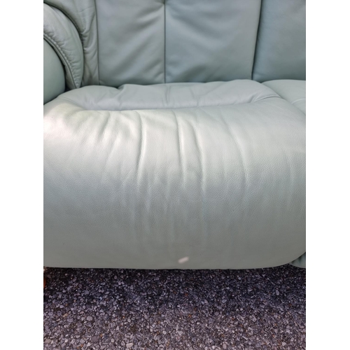 1068 - A pair of Himolla 'Chester' pale green leather reclining and swivel easy chairs.