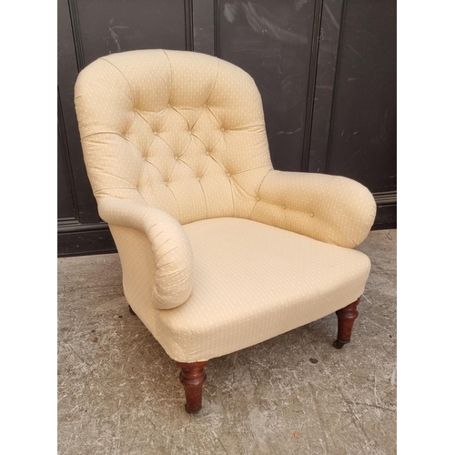 1069 - A Victorian button upholstered occasional armchair.