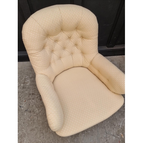 1069 - A Victorian button upholstered occasional armchair.