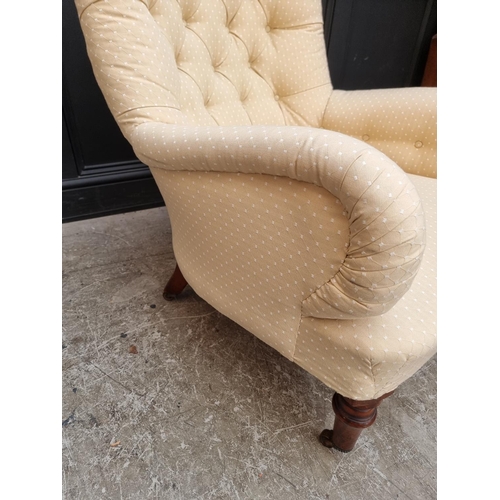 1069 - A Victorian button upholstered occasional armchair.