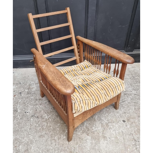 1071 - An Arts & Crafts style oak reclining armchair, in the manner of Morris & Co.... 