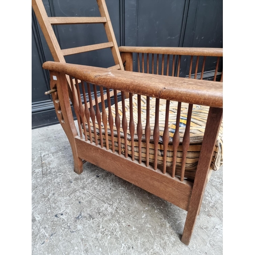 1071 - An Arts & Crafts style oak reclining armchair, in the manner of Morris & Co.... 