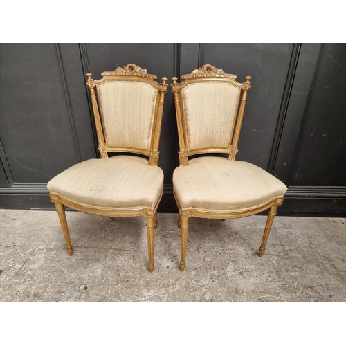 1076 - A pair of Louis XVI style giltwood salon chairs. (2)