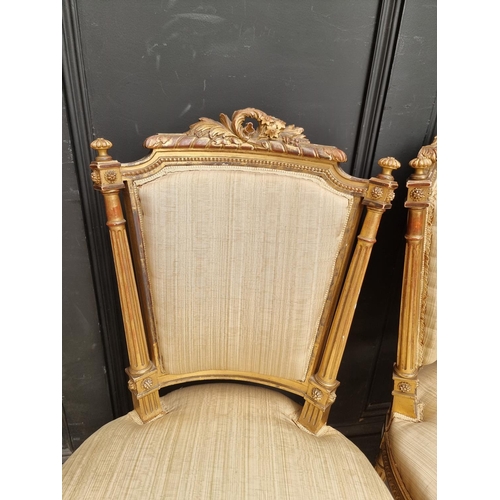 1076 - A pair of Louis XVI style giltwood salon chairs. (2)