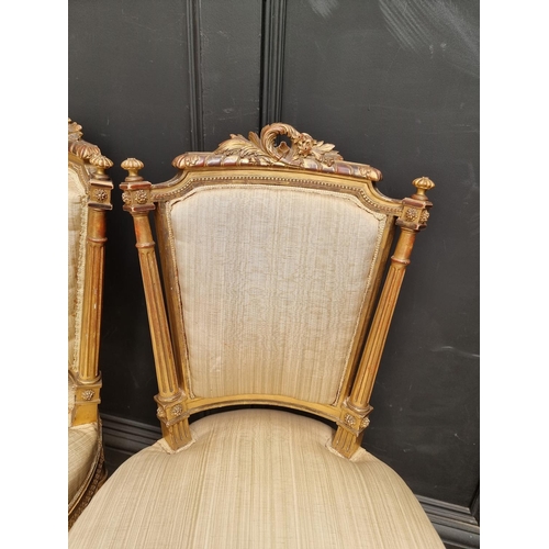 1076 - A pair of Louis XVI style giltwood salon chairs. (2)