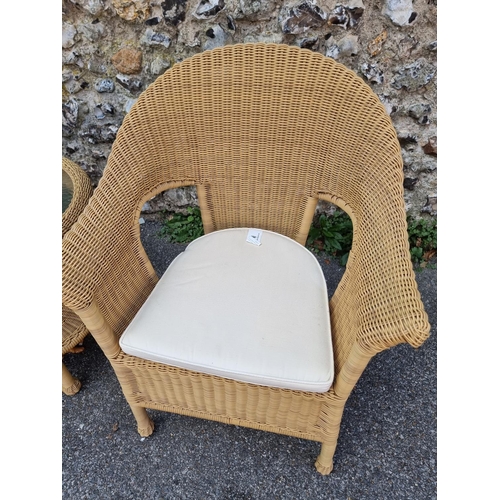 1082 - A pair of simulated wicker conservatory chairs and matching circular table, by Summer Castle, the ta... 