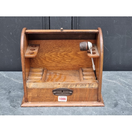 1086 - An early 20th century oak tambour top smoker's cabinet, 30cm wide.