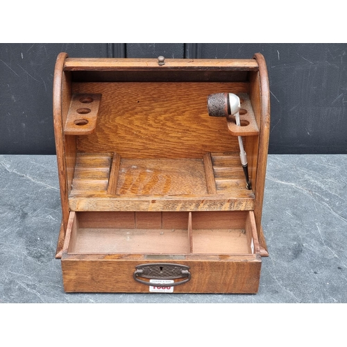 1086 - An early 20th century oak tambour top smoker's cabinet, 30cm wide.