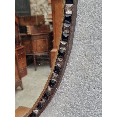 1089 - A large Irish style oval wall mirror, bearing label, 87 x 61.5cm.