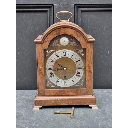 1097 - A walnut dome top mantel clock, by Elliott, striking on eight gongs, 37cm high.... 