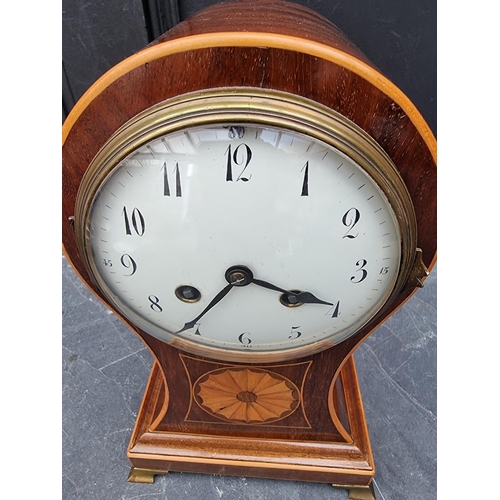 1102 - A circa 1900 mahogany and inlaid balloon form mantle clock, 29cm high, with pendulum.... 