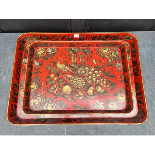 1110 - A good graduated pair of 19th century papier mache trays, with gilt decoration on a scarlet red grou... 