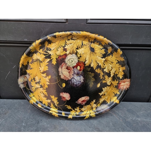 1111 - A good graduated pair of 19th century papier mache oval trays, with painted and gilded decoration, l... 