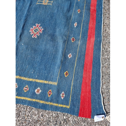 1118 - A Moroccan flat weave rug, on blue ground, 249 x 167.