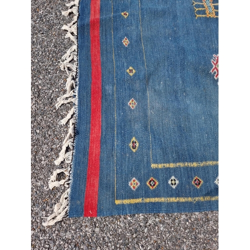 1118 - A Moroccan flat weave rug, on blue ground, 249 x 167.