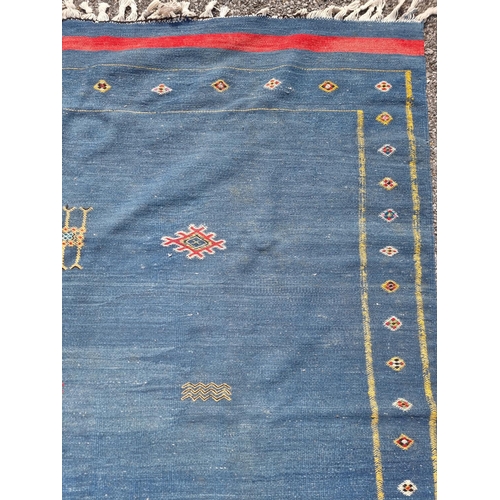 1118 - A Moroccan flat weave rug, on blue ground, 249 x 167.