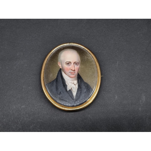 1200 - English School, 19th century, head and shoulders portrait miniature of a gentleman wearing a black j... 