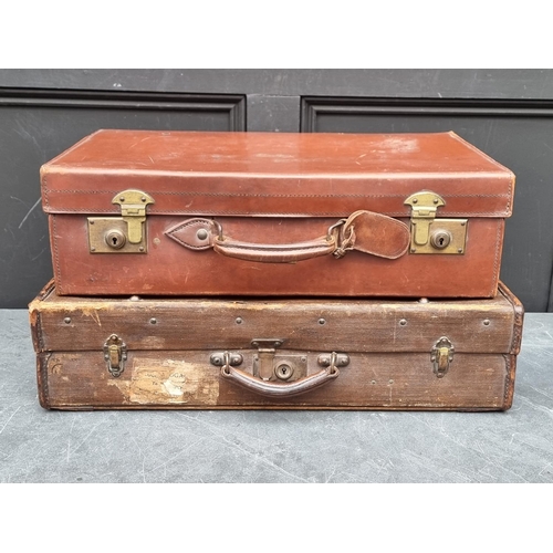 1242 - A vintage brown leather suitcase, 61cm wide; together with another canvas example. (2) ... 