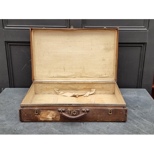 1242 - A vintage brown leather suitcase, 61cm wide; together with another canvas example. (2) ... 