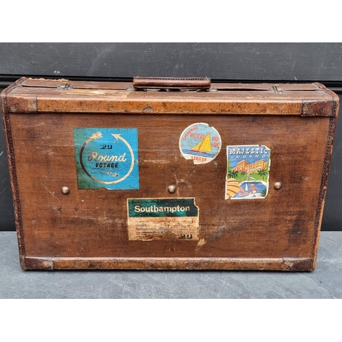 1242 - A vintage brown leather suitcase, 61cm wide; together with another canvas example. (2) ... 