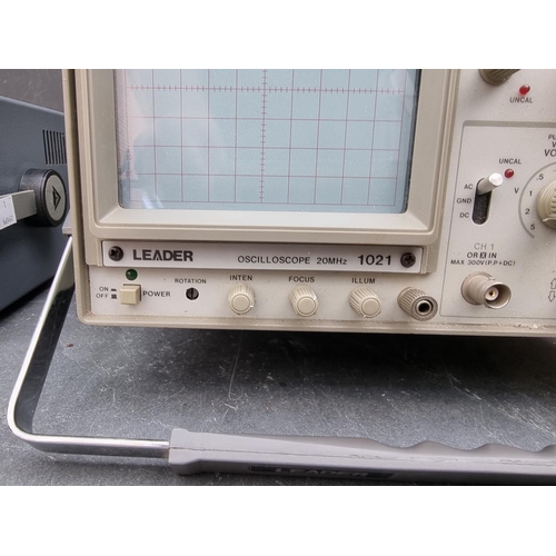 1247 - A Leader 1021 Oscilloscope; together with a similar Advance OS140 example, each with power lead; and... 