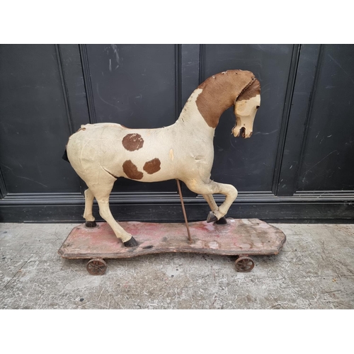 1248 - An antique French push-along horse, with pony hide skin, 114.5cm long.