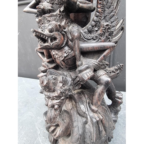 1274 - A Balinese carved hardwood sculpture, 42cm high. 