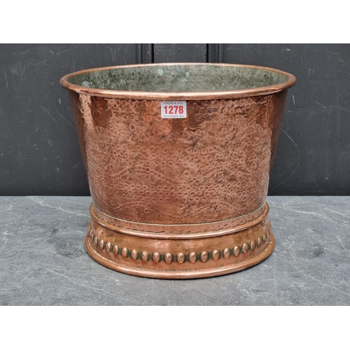 1278 - A hammered copper jardiniere, 25.5cm high x 33.5cm diameter.