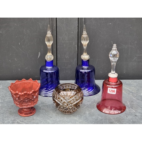 1296 - A pair of Bristol blue glass bells, 29.5cm high; together with another cranberry glass example; a ma... 