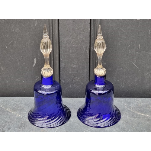 1296 - A pair of Bristol blue glass bells, 29.5cm high; together with another cranberry glass example; a ma... 