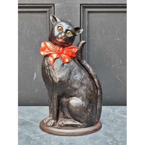 1300 - An antique cast iron Cat doorstop, with glass eyes, 37cm high.