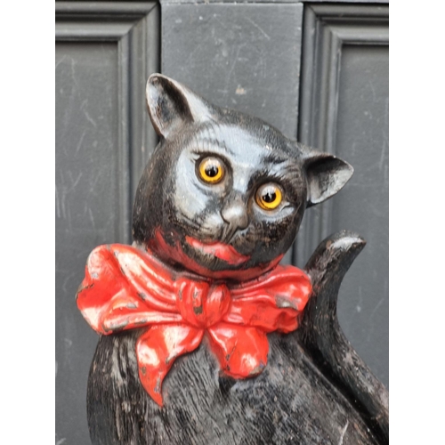 1300 - An antique cast iron Cat doorstop, with glass eyes, 37cm high.