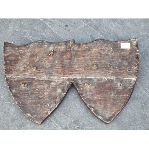 1301 - An old oak conjoined shield plaque, mounted with two heraldic tigers, 36.5cm wide.