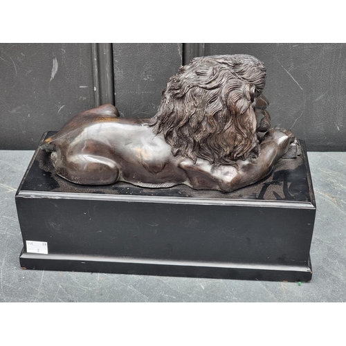 1337 - A bronze recumbent Lion, in the manner of Antonio Canova, on ebonized base, 32.5cm wide.... 