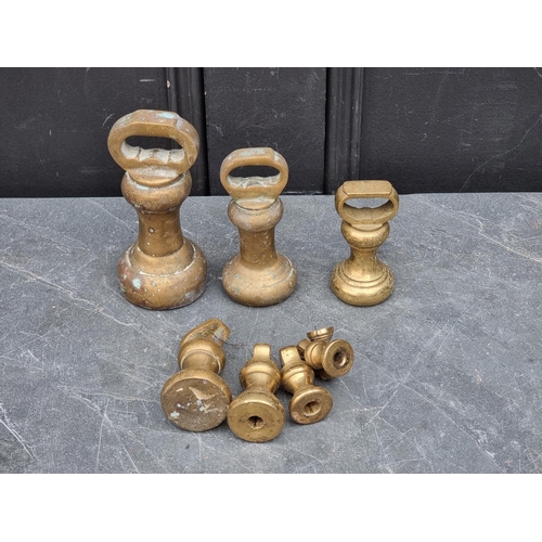 1341 - A graduated set of brass weights. (9)