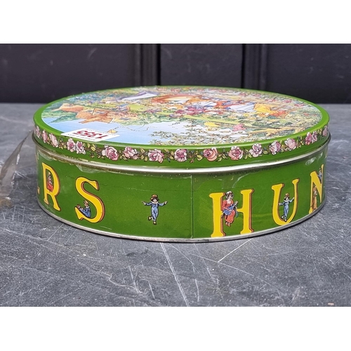 1355 - A Huntley & Palmers 'Naughty' biscuit tin, sealed and with contents. 