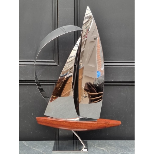 1357 - John Mellows, a metal and wood sculpture of a yacht, 82cm high.