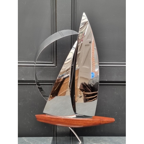 1357 - John Mellows, a metal and wood sculpture of a yacht, 82cm high.