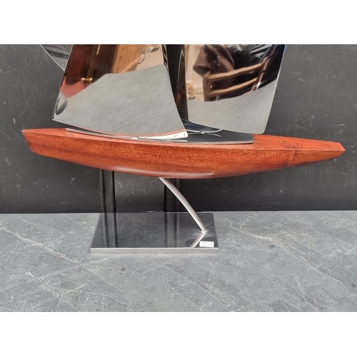 1357 - John Mellows, a metal and wood sculpture of a yacht, 82cm high.